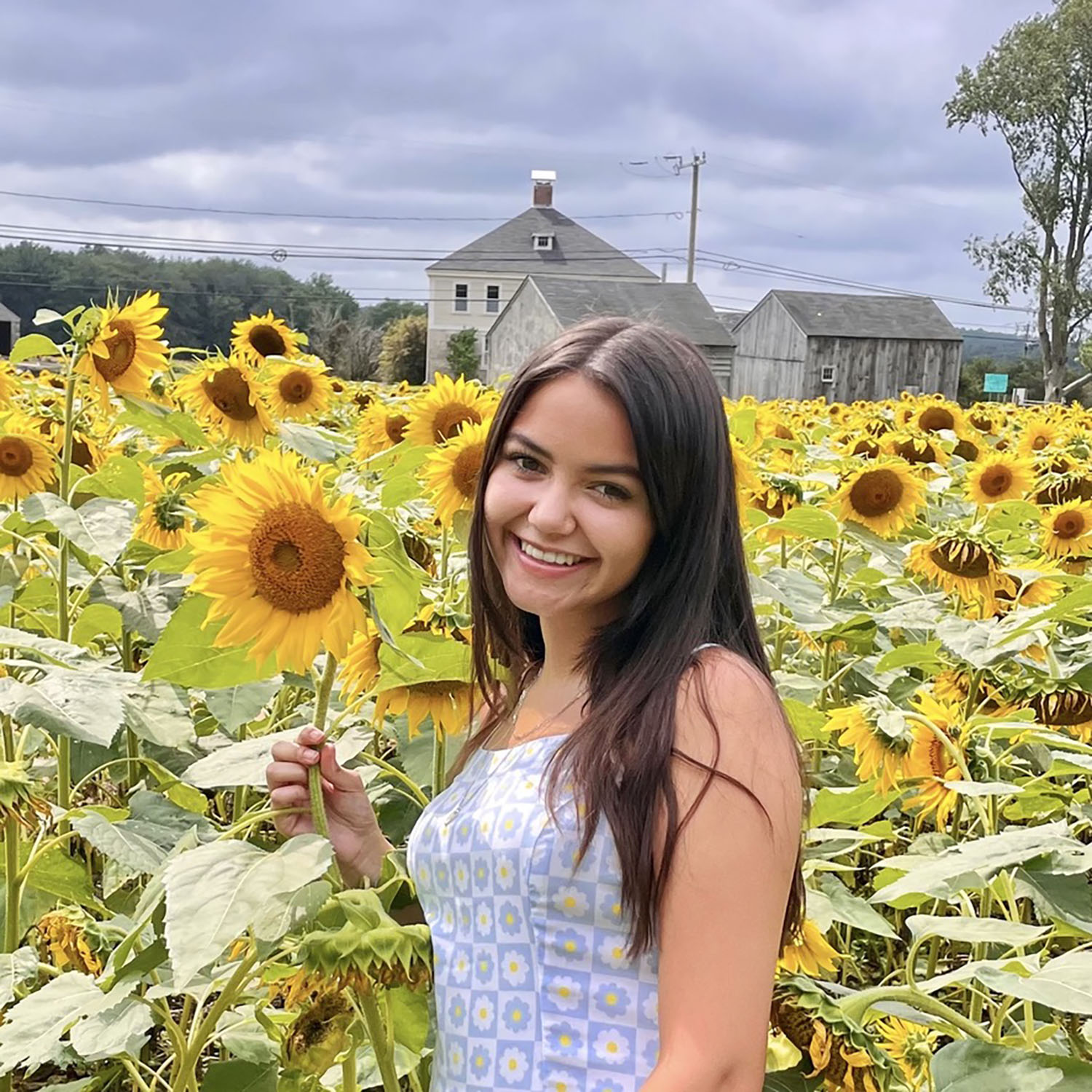 Nicole Burgon ’25 in a sunflower field.