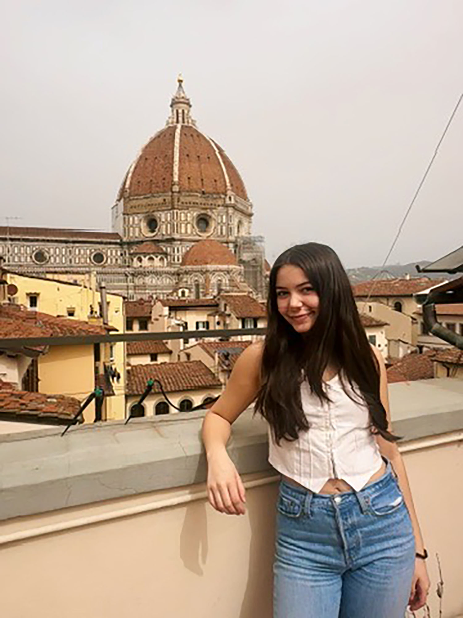 Nicole Burgon ’25 with a cathedral in the background.