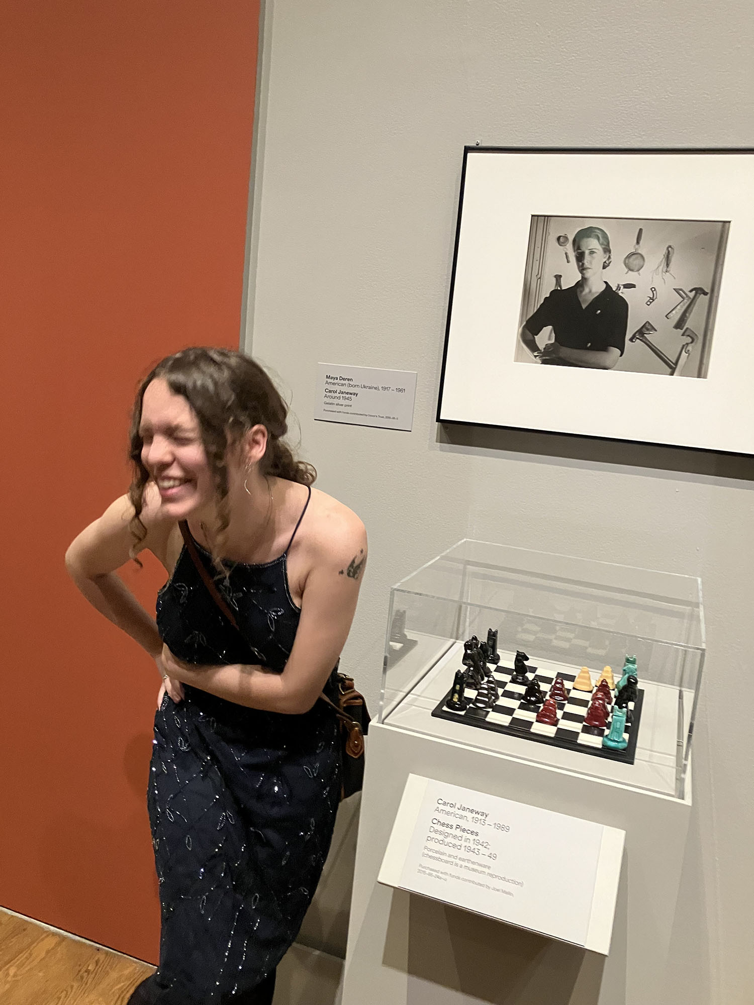 Maddie Lush ’25 laughing next to an art piece.