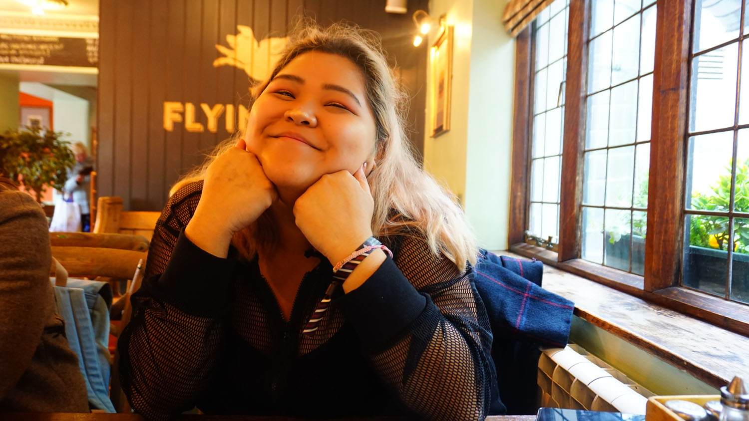 Tina Nguyen ’25M sitting in a restaurant.