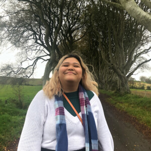 Tina Nguyen ’25M in front of some trees.
