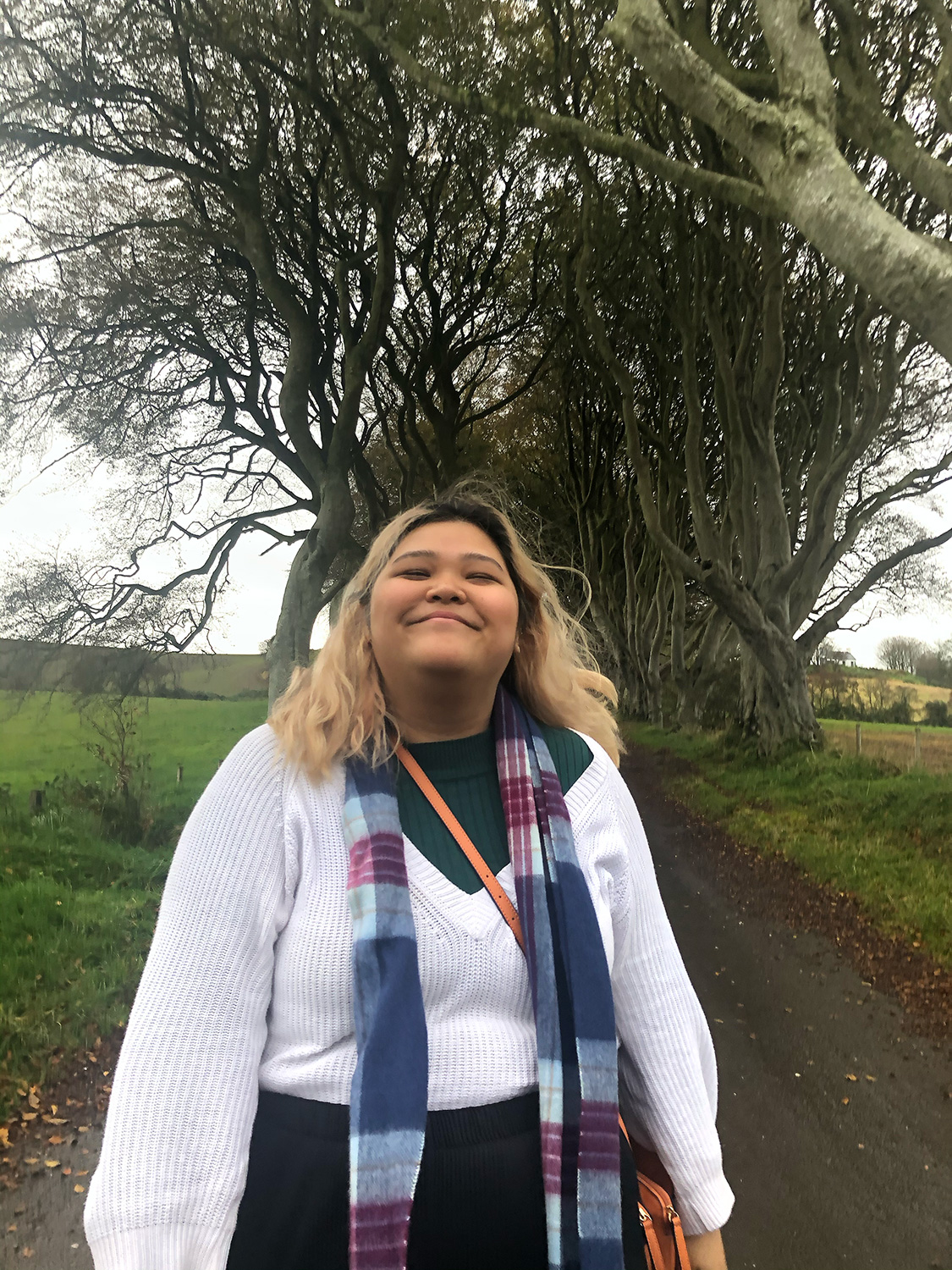 Tina Nguyen ’25M in front of some trees.