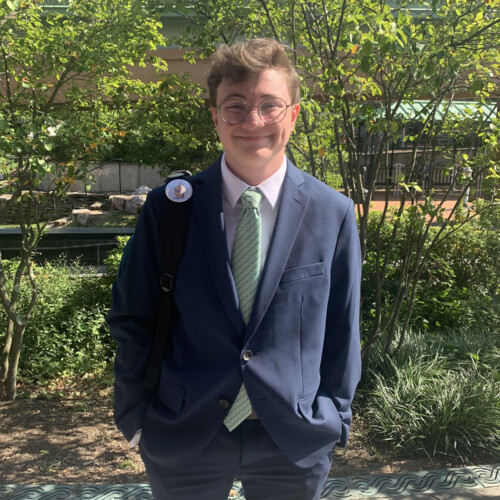 Elliot Vasey ’25 in front of some trees.