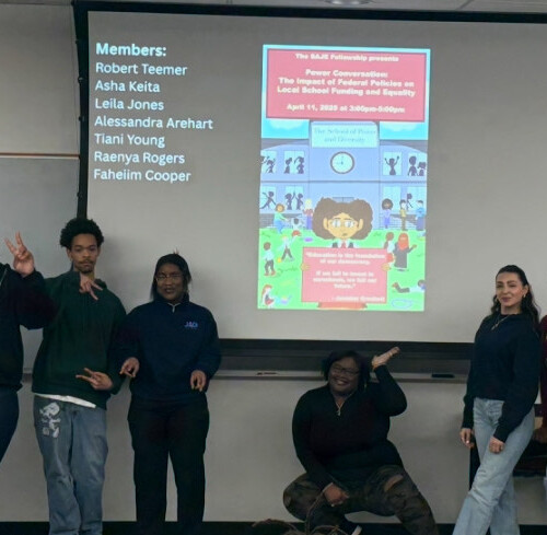 SAJE Fellows standing in front of their presentation.