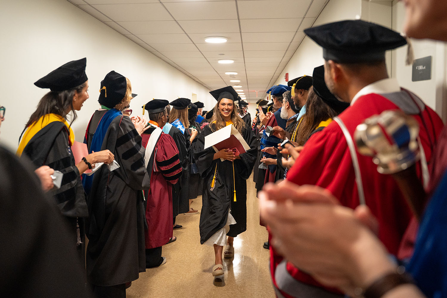 A student walking through the honor guard.