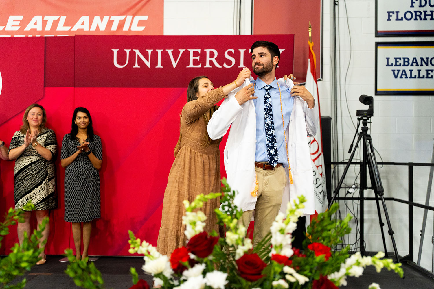 A student receiving their white coat.