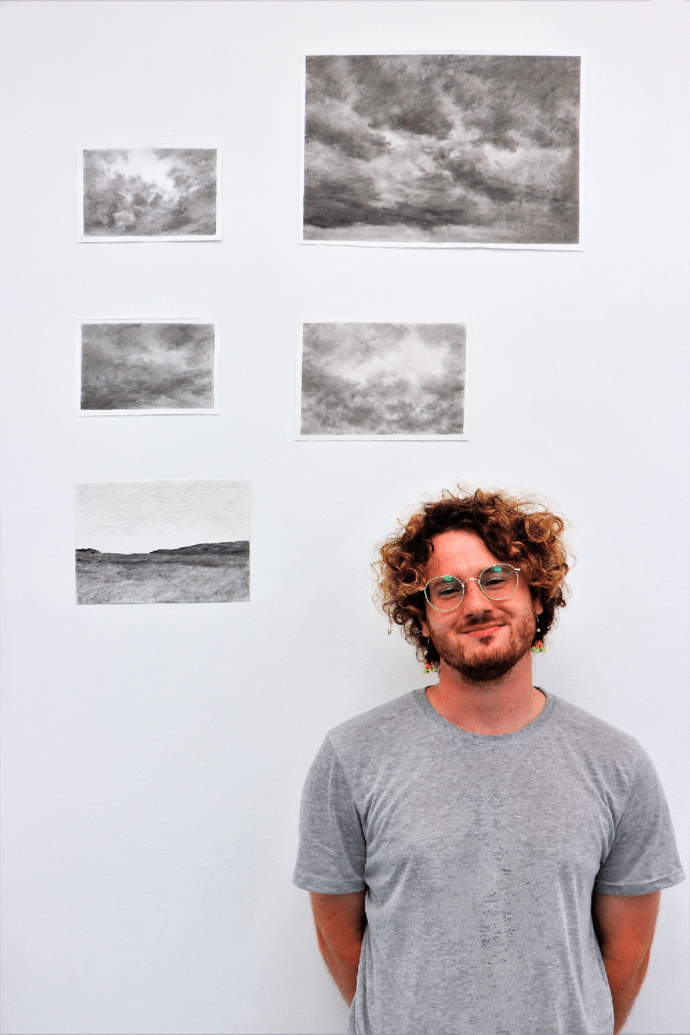 Wilkes ’25 in front of his photos.