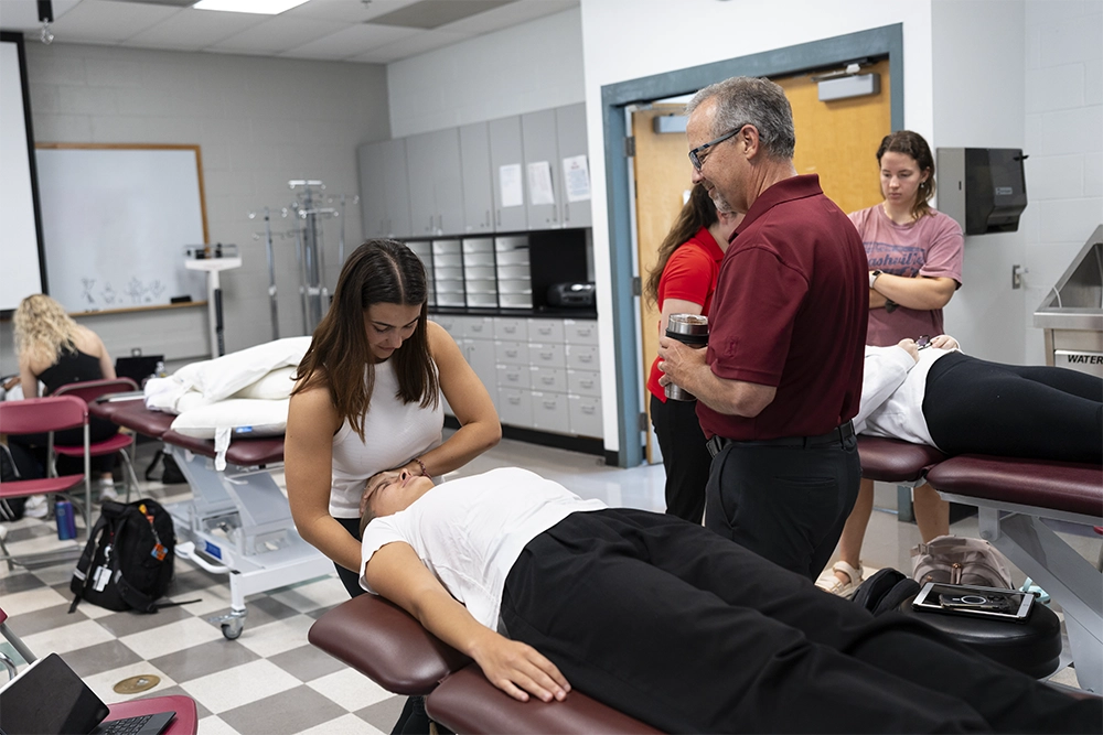 Physical therapy students practice healthcare applications in a clinical setting.