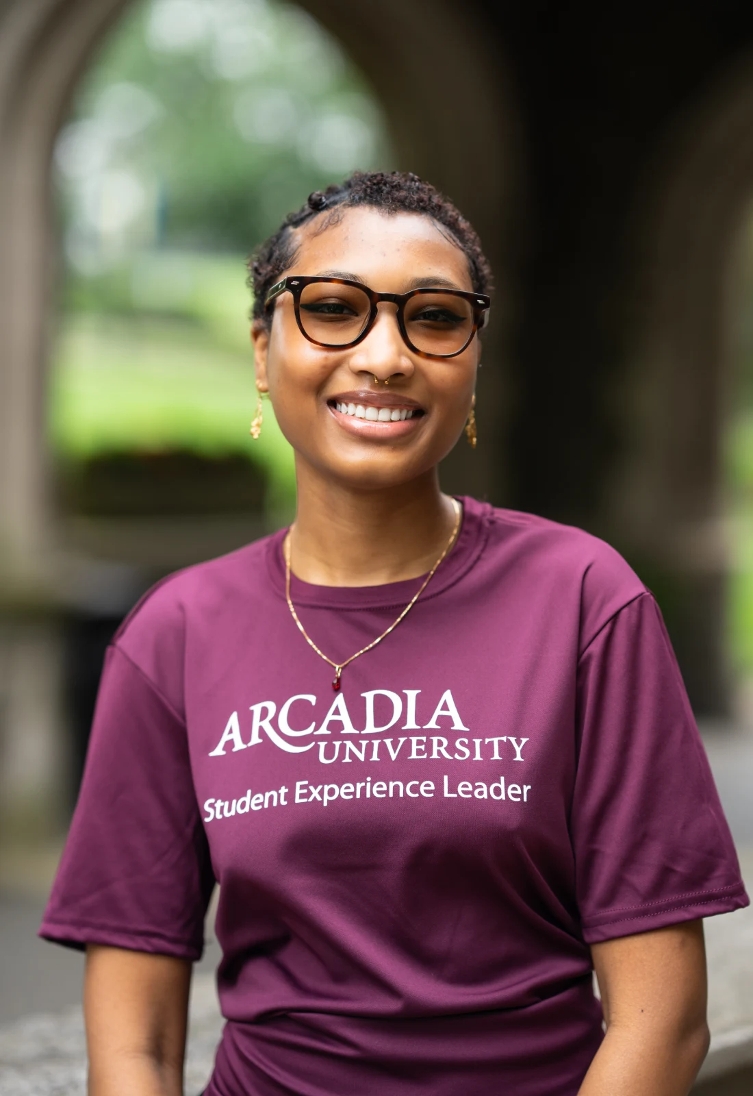 Headshot of Alexia Habib wearing a purple Student Experience Leader t-shirt.