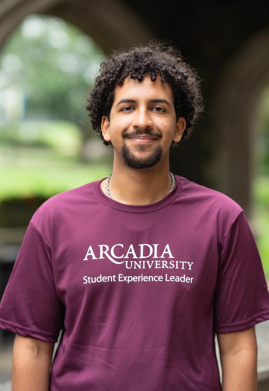 Headshot of Ian Catalina Vasquez wearing a purple Student Experience Leader t-shirt.
