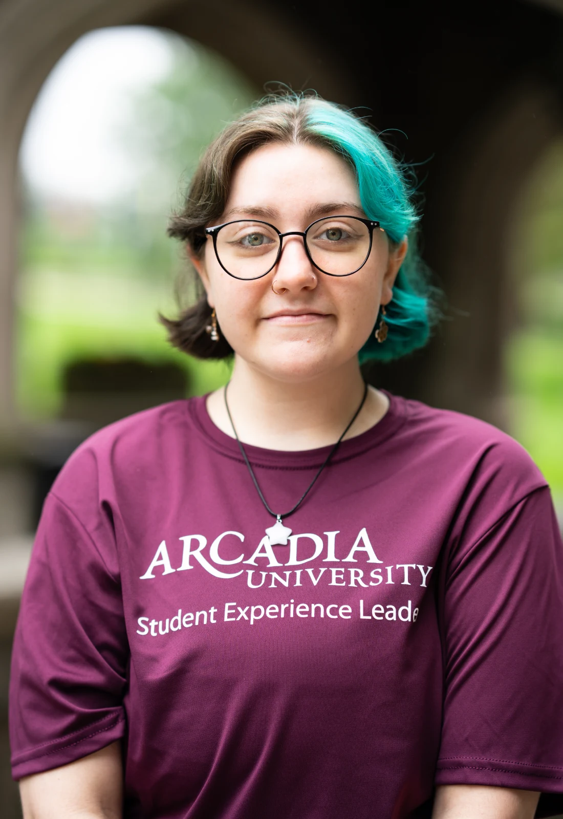 Headshot of Maze Herbst wearing a purple Student Experience Leader t-shirt.