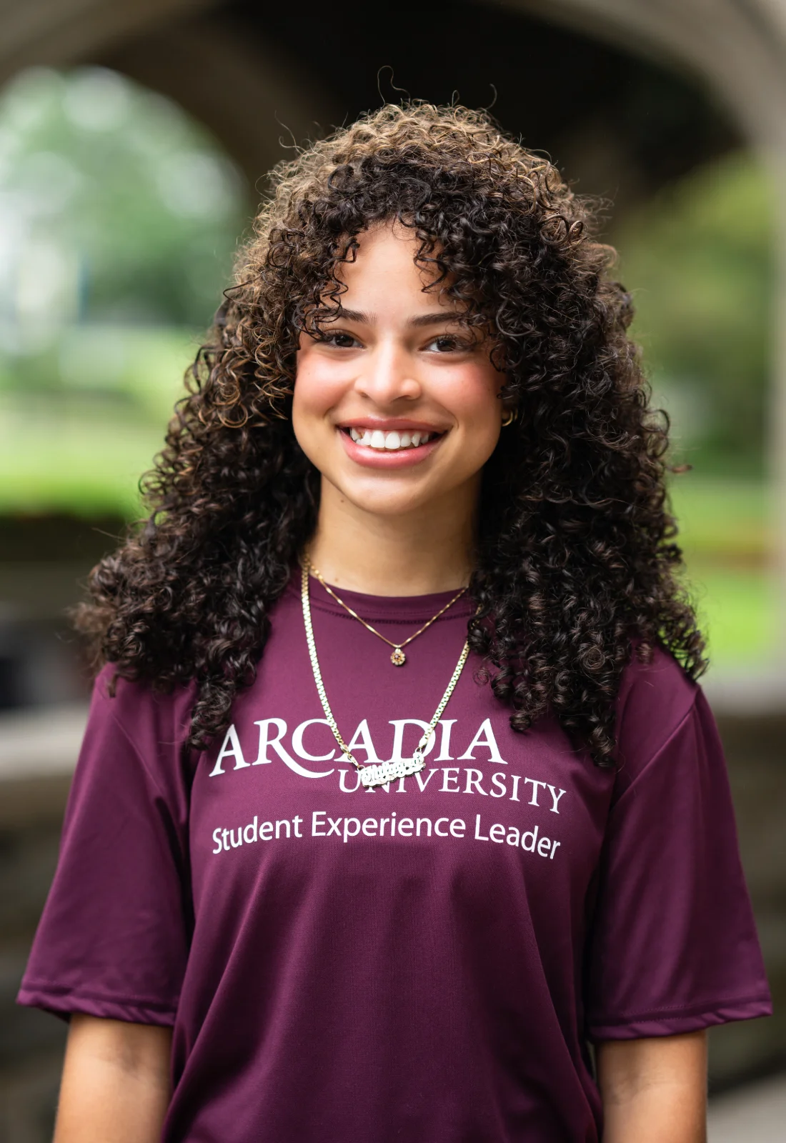 Headshot of Milagro Duran wearing a purple Student Experience Leader t-shirt.