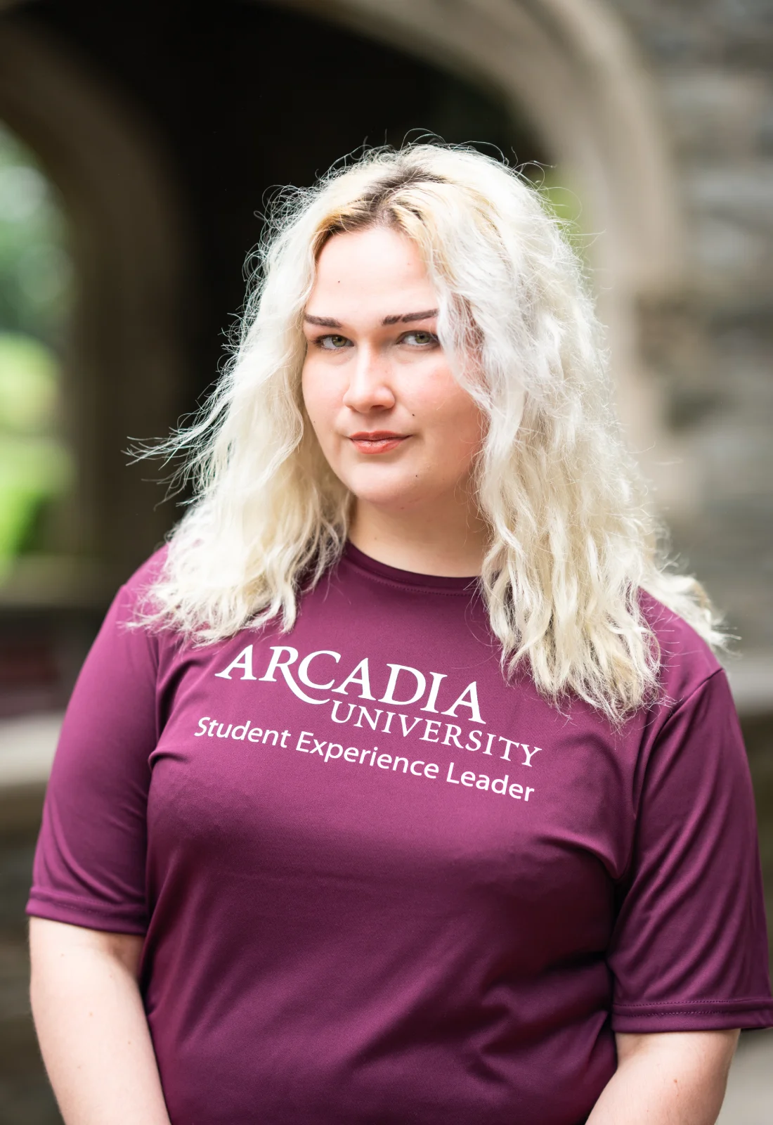 Headshot of Miranda Razzi wearing a purple Student Experience Leader t-shirt.