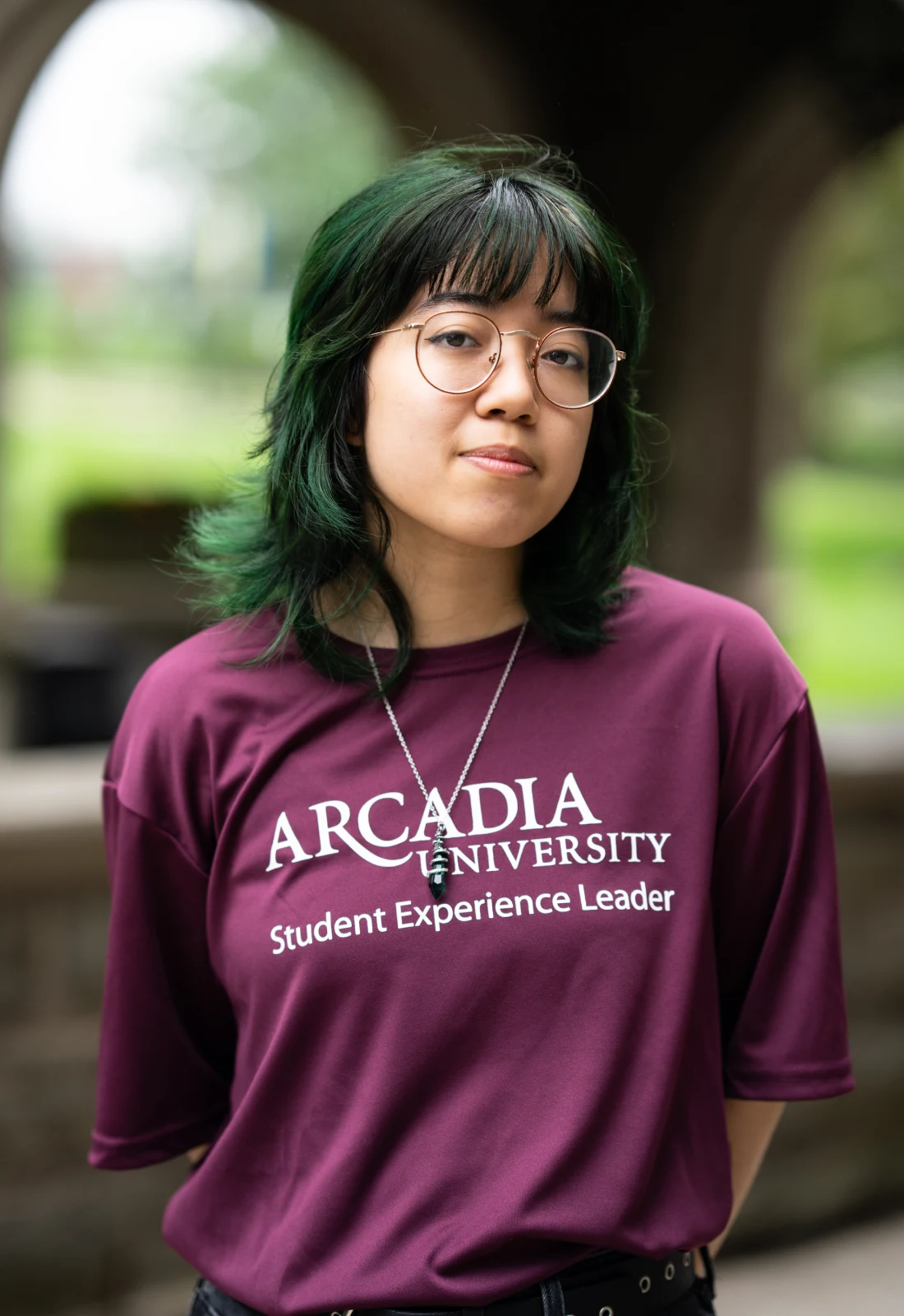 Headshot of Ven Mubarak wearing a purple Student Experience Leader t-shirt.