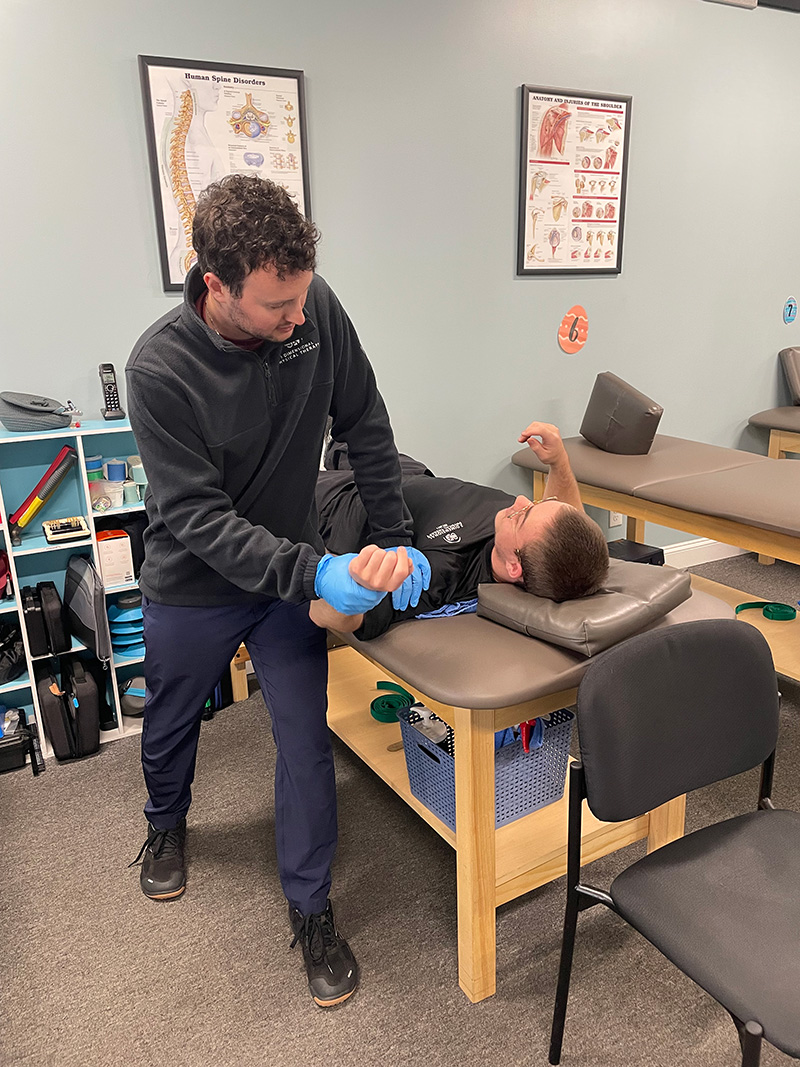 Michael Zlotnick ’22DPT demonstrating his approach to patient care with his PT aide Elliot Sykes
