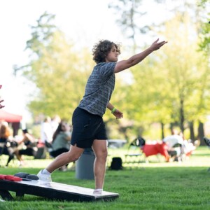 Two Arcadia University students play a game of cornhole on Haber Green