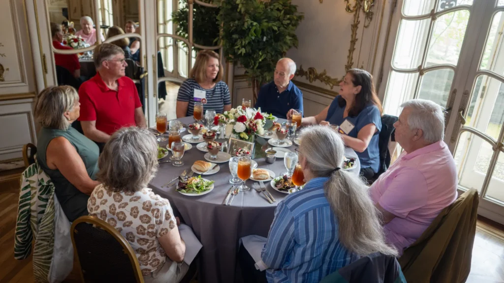 Group of people seated around a nicely decorated table.