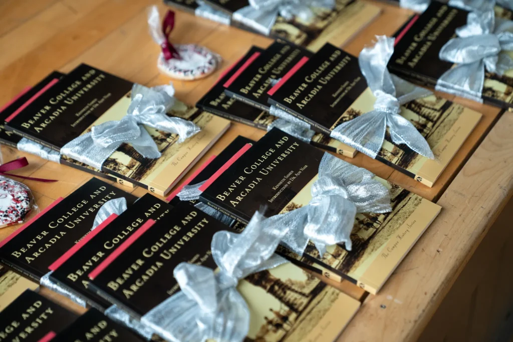 Alumni written book wrapped in a red bow.
