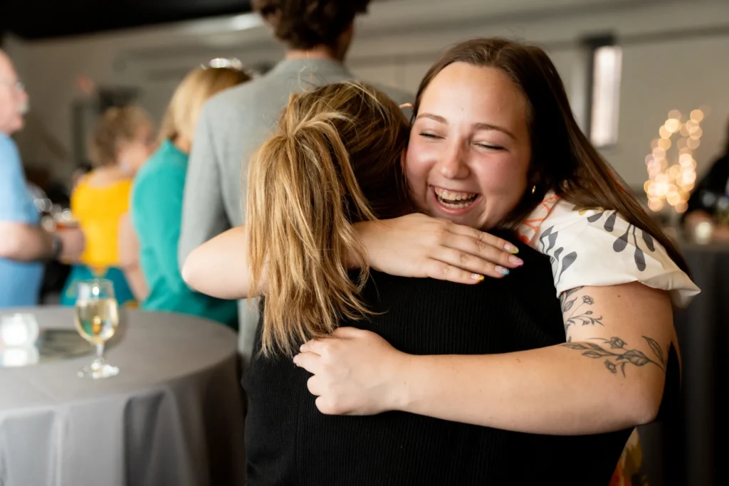Two women are hugging.