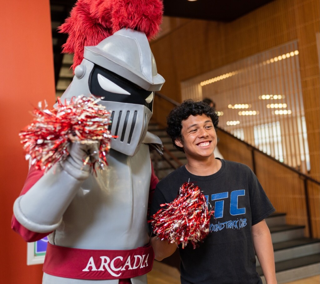 SA student smiles with Archie on campus.
