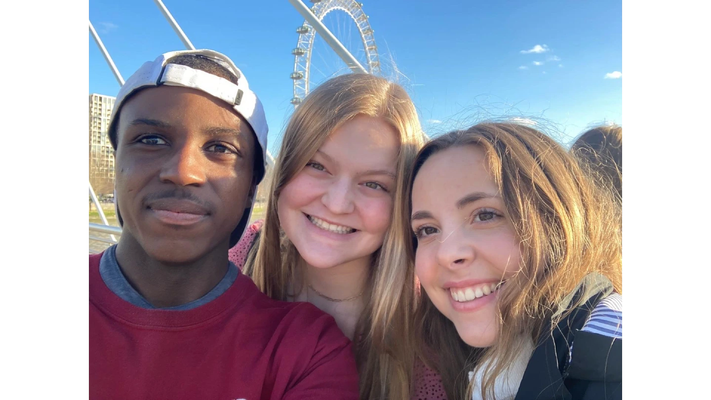 Three Arcadia students take a selfie in front of the London Eye in London, England.
