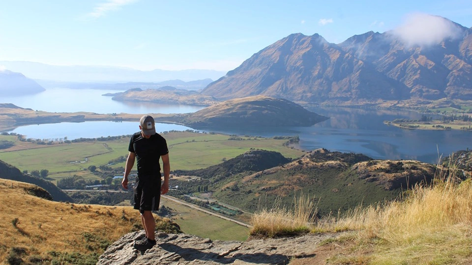 An Arcadia student poses in front of a beautiful landscape view in New Zealand.