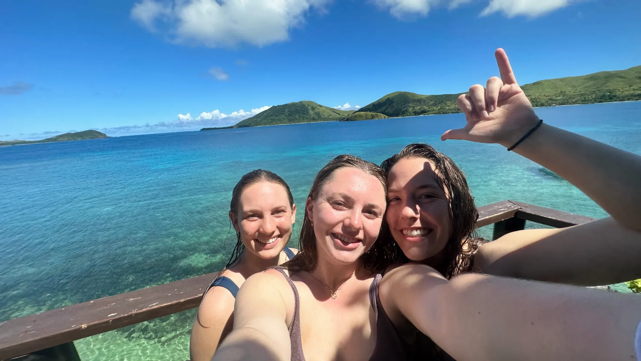 A group of Arcadia students take a selfie by the water in Fiji.