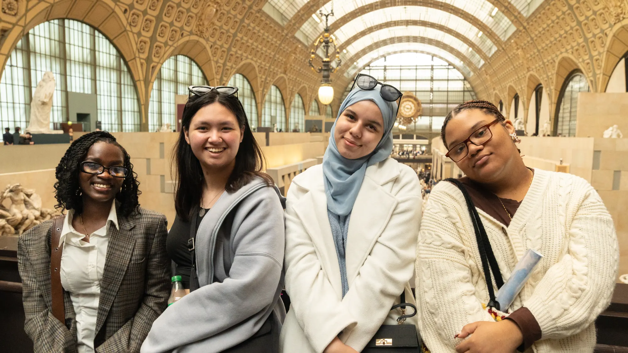 Four Arcadia students stand inside the Musée d'Orsay in Paris, France during their time studying abroad.