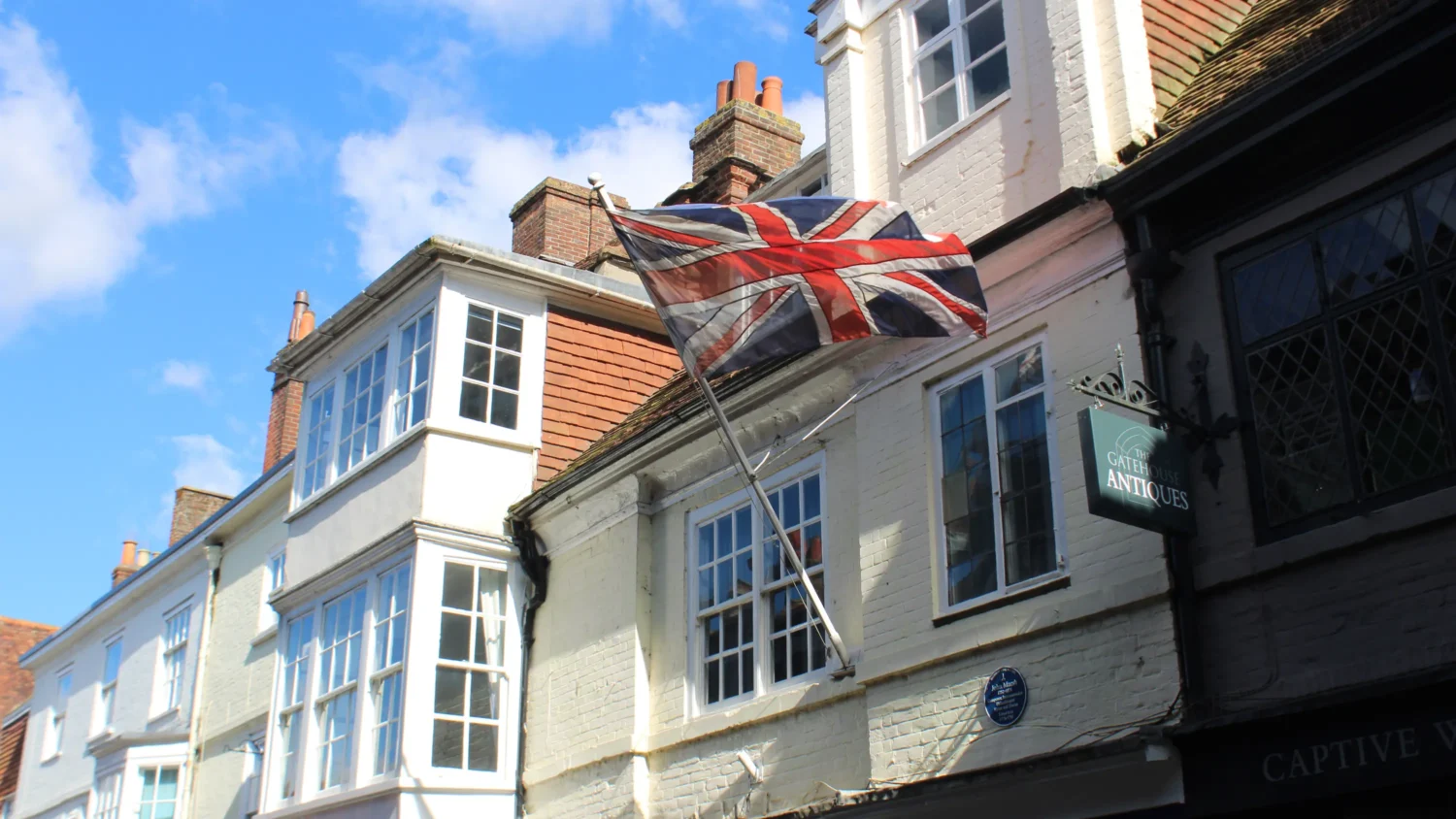 A flag of the Union Jack is flown on the side of a shop in London.