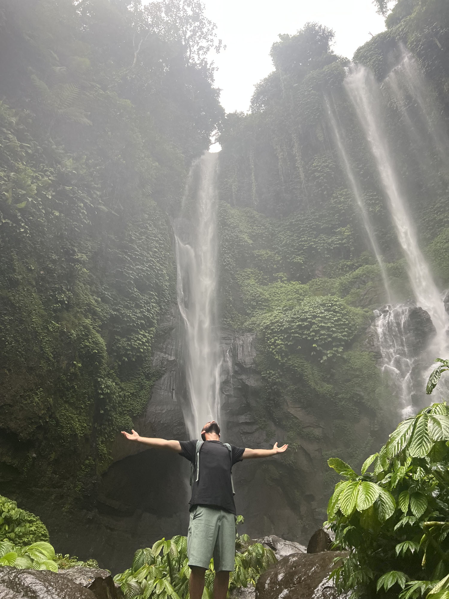 Zachary Runkle ’23, ’27DPT standing in front of a waterfall.
