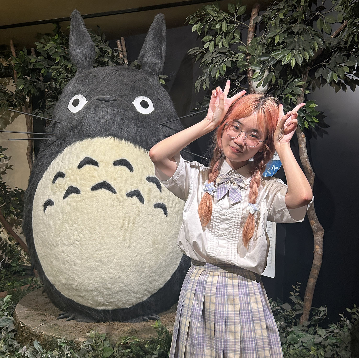 Sue Anne Hong ’27 standing with a Totoro statue.