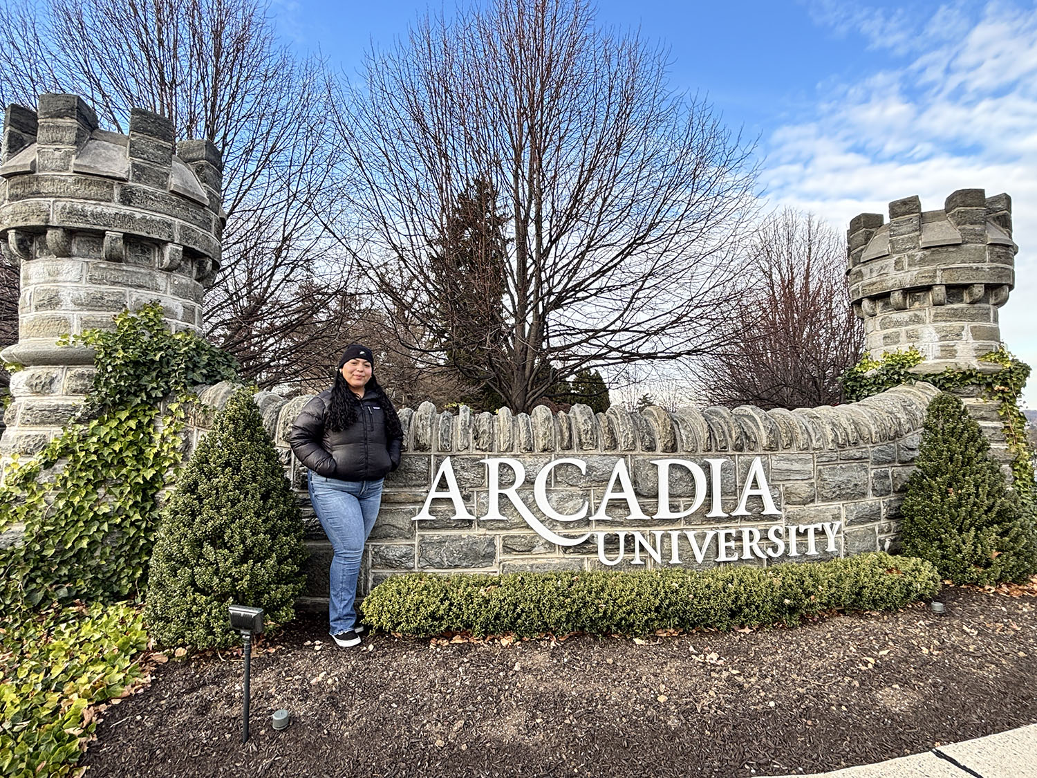 Fatima Frias-Perez ’29 in front of the entrance to campus.