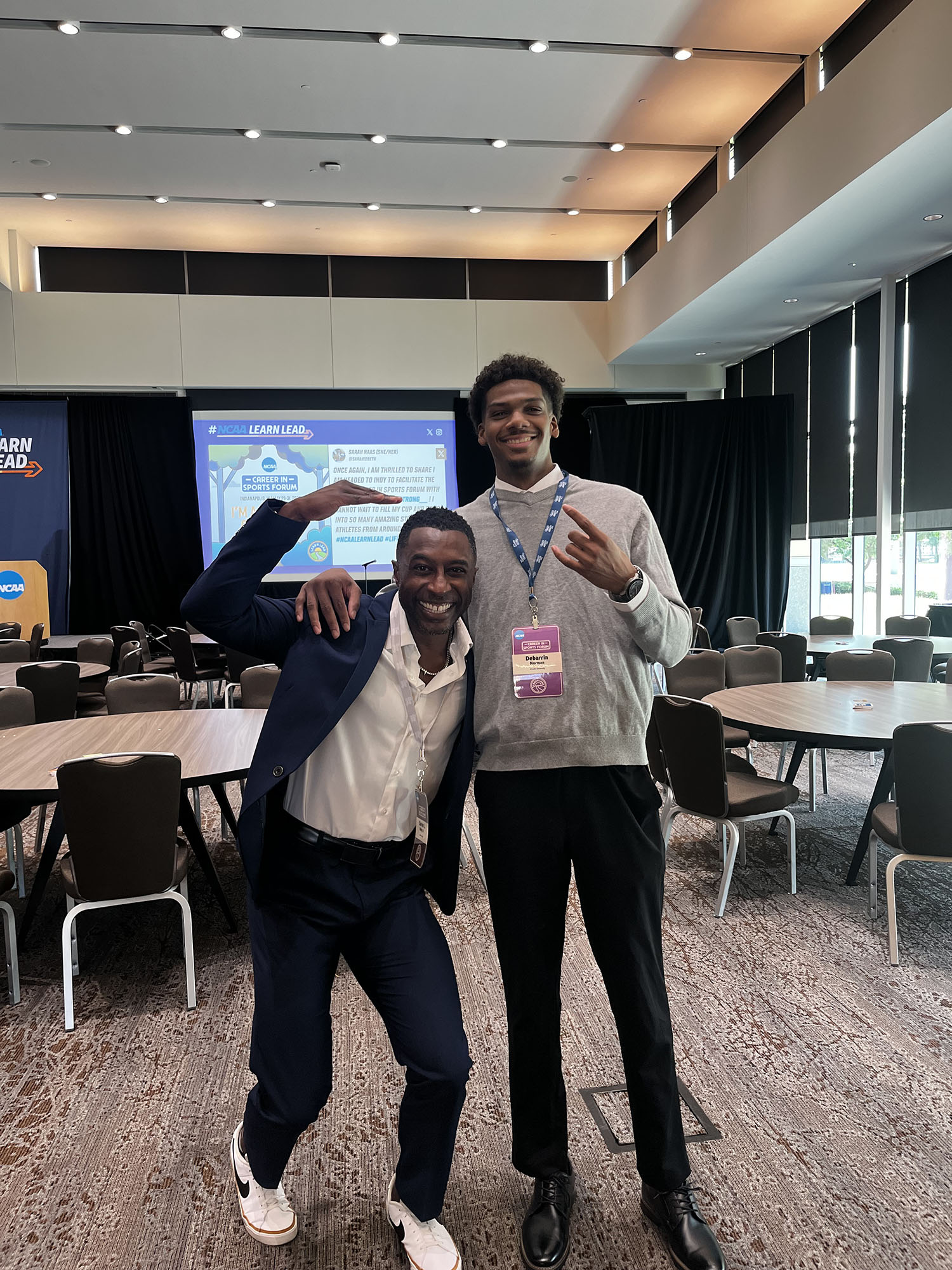 Debarrin Norman ’26 with another man at the Career in Sports Forum.