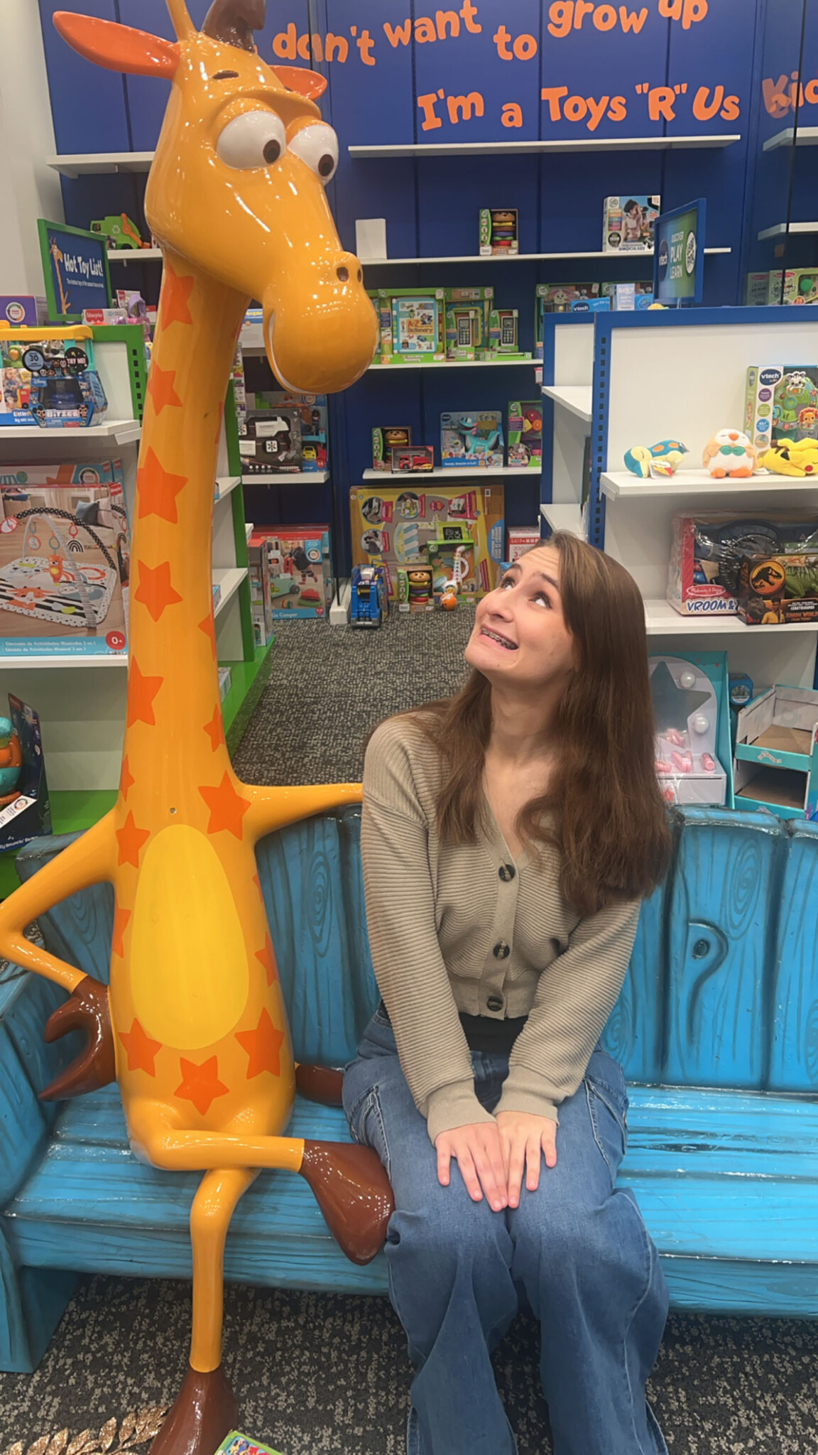 Carly Ruchalski ’29 sitting with Jeffrey, the Toys R Us mascot.