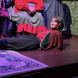 Carly Ruchalski ’29 laying on the stage.