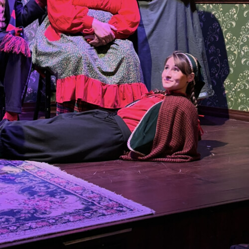 Carly Ruchalski ’29 laying on the stage.