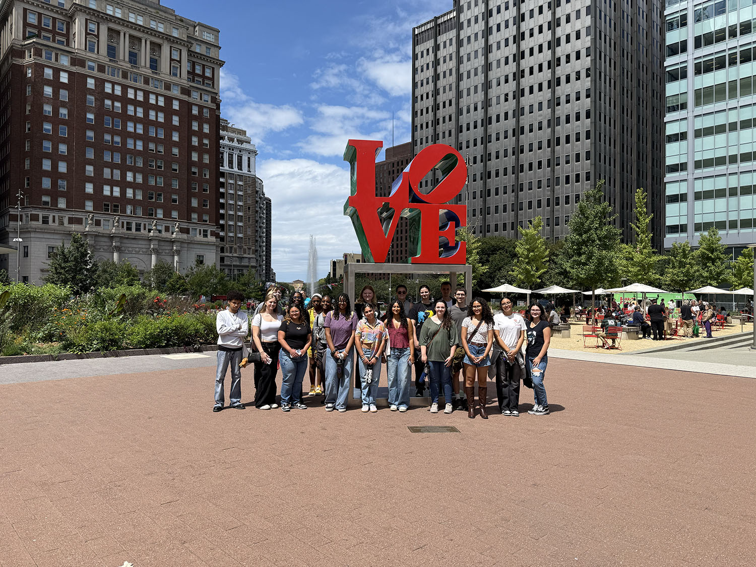 START students in front of the LOVE sign.