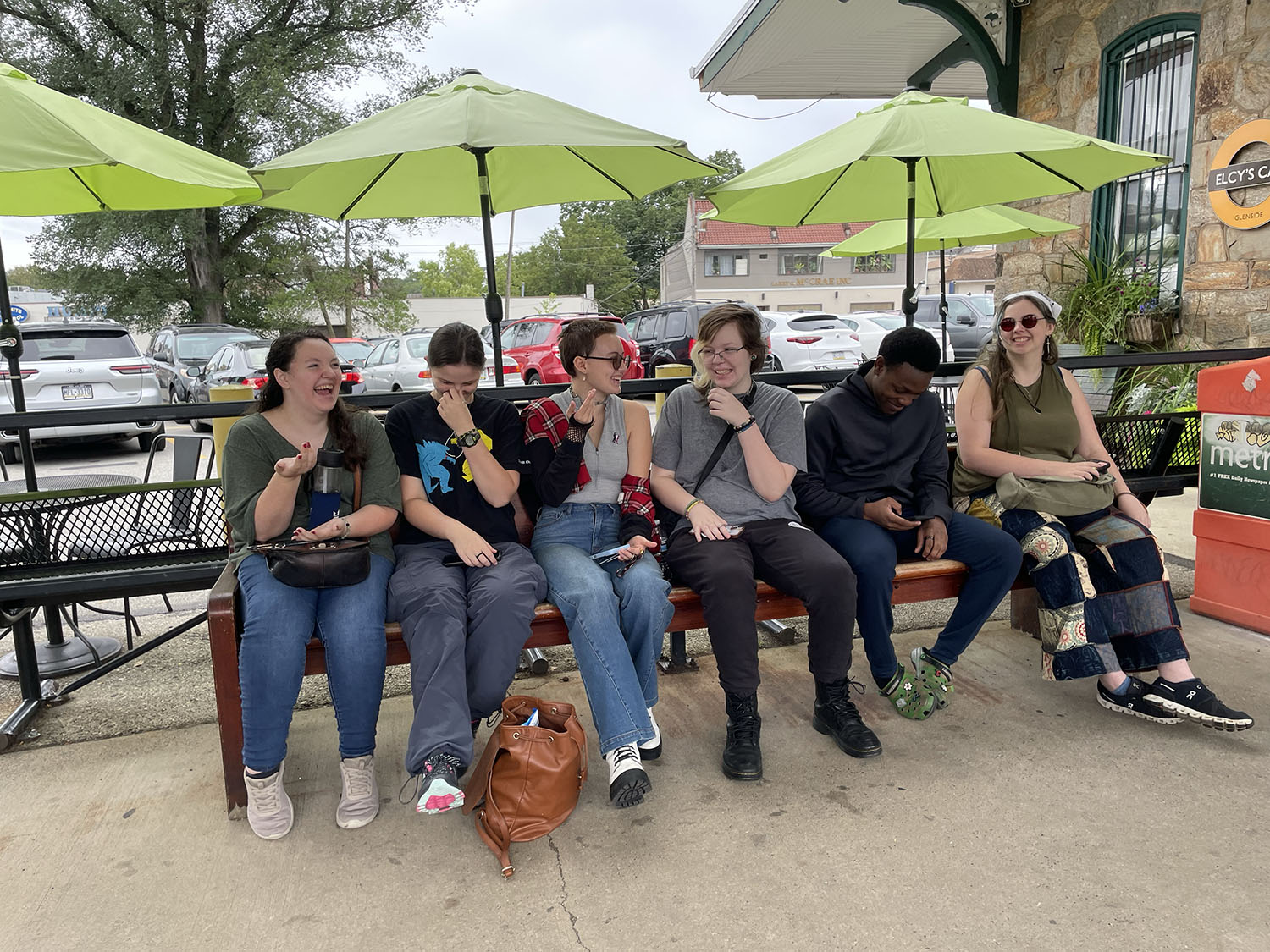 START students laughing on the bench.