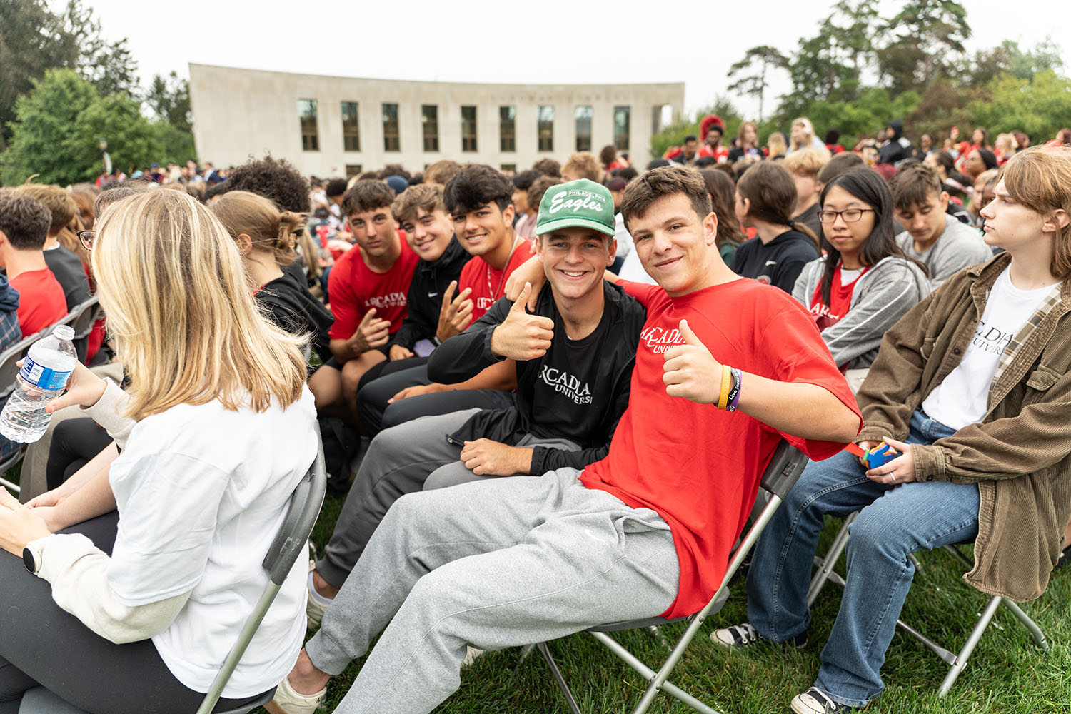 Two students giving a thumbs up at Convocation.
