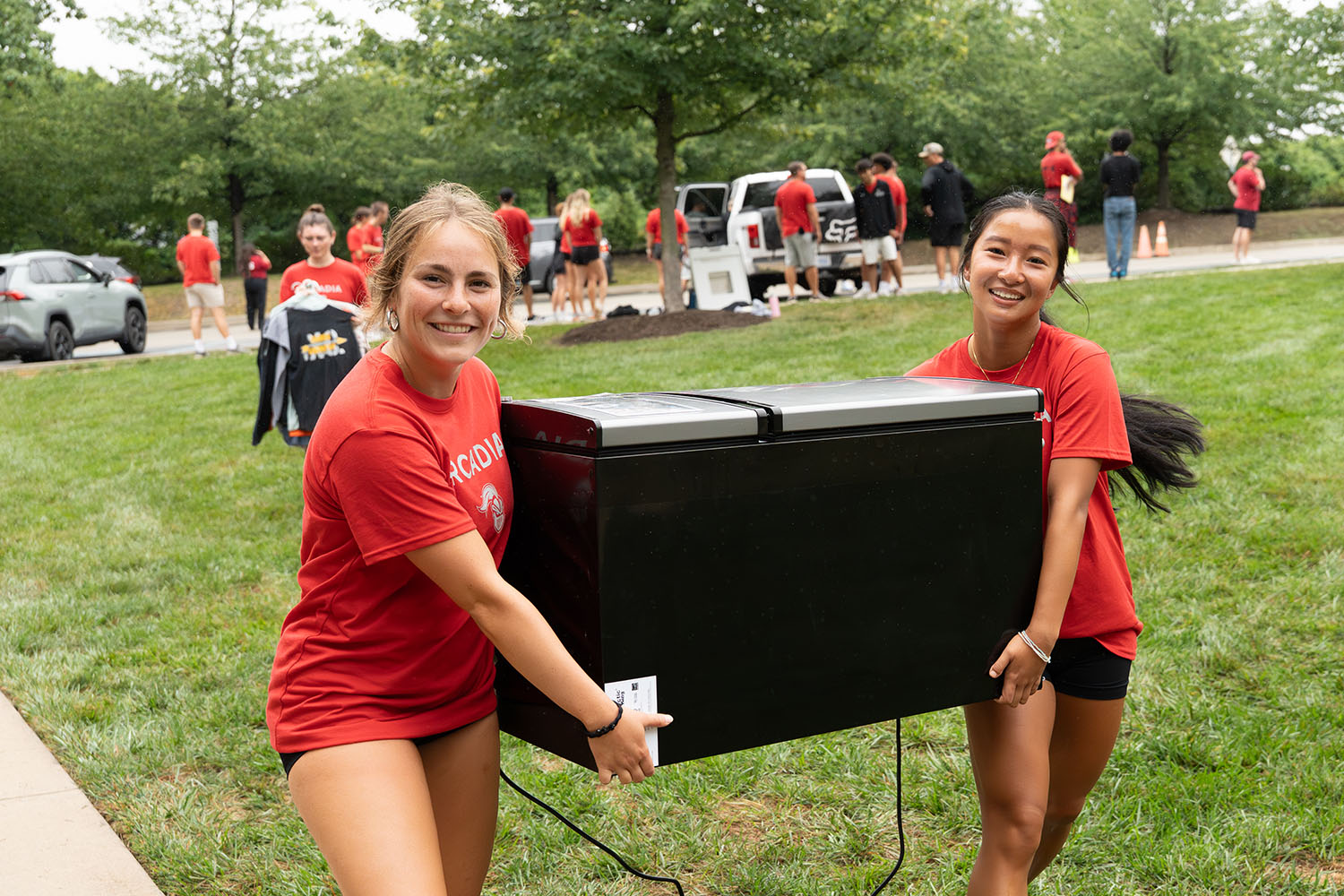 Student-athletes carrying a fridge.