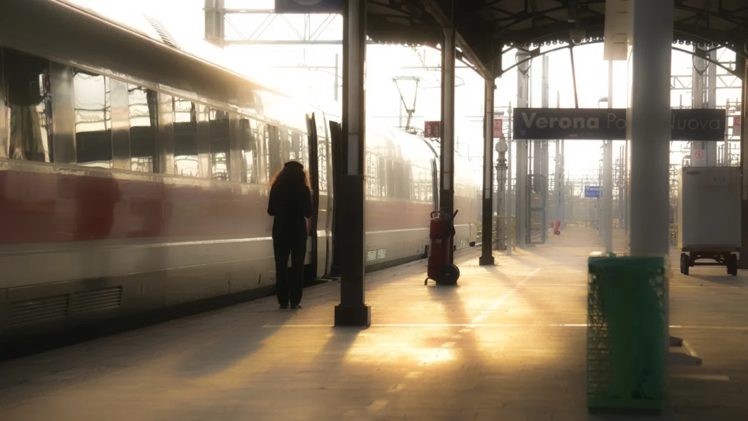 An Arcadia student stands next to a train in an empty subway station.