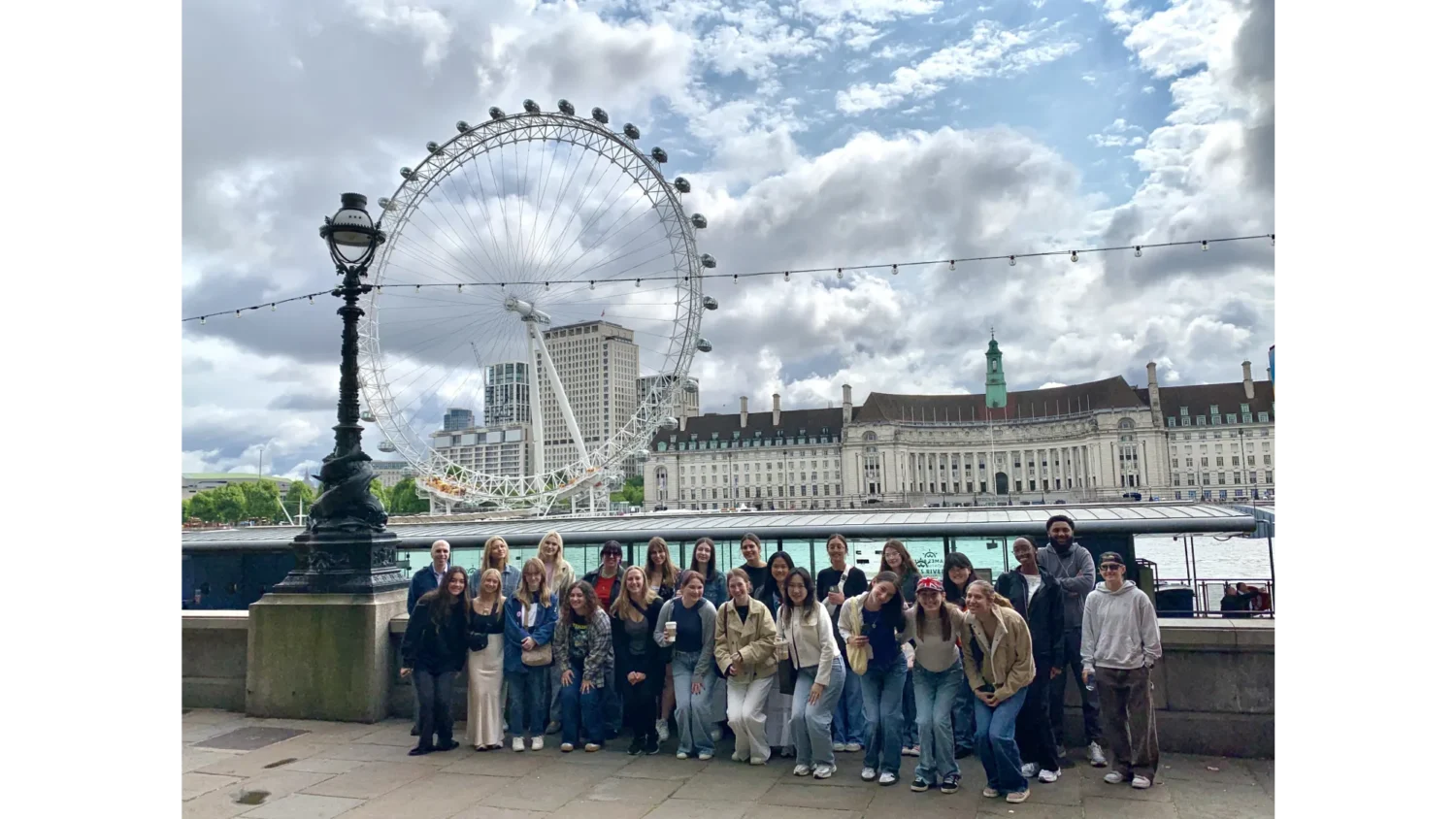A group of Arcadia students pose in front of the London Eye in London, England.