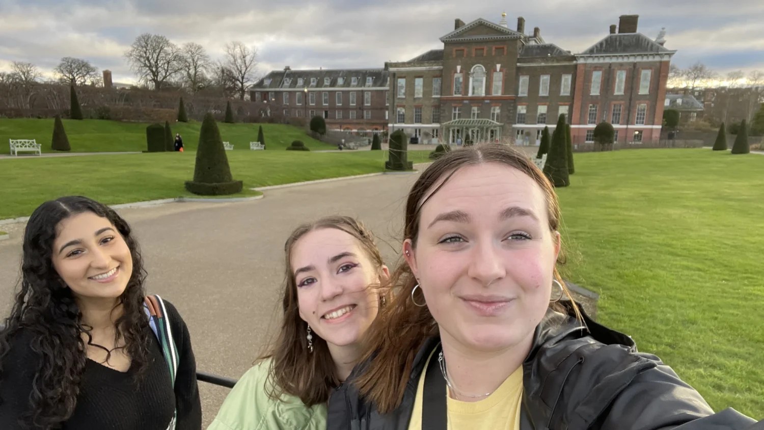 Three Arcadia students pose for a selfie in front of a building in London, England.