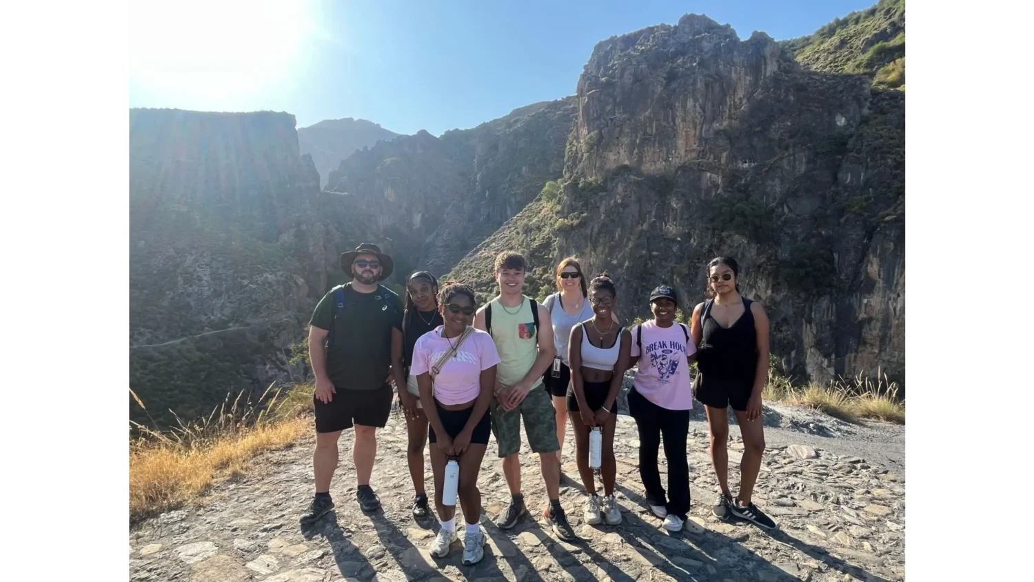 A group of Arcadia students pose in front of a mountain view in Granada, Spain.