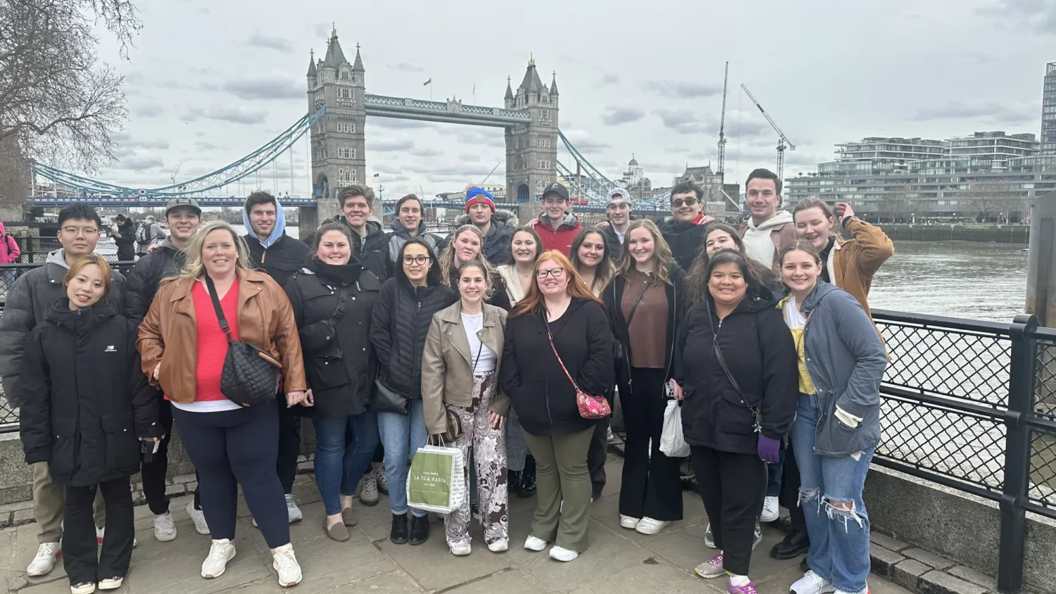 A group of Arcadia students pose for a picture in front of the Tower Bridge in London, England