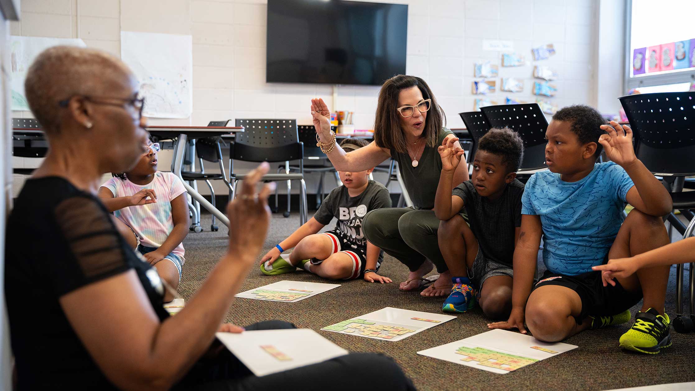 Teachers interacting with children in a classroom