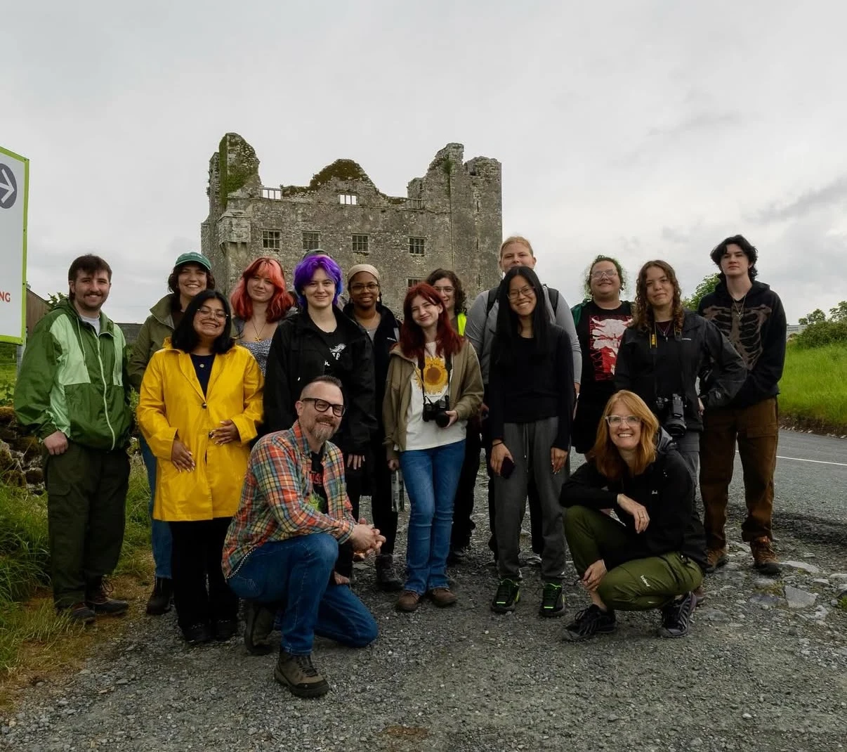 A group of Arcadia students pose in front of a castle in Ireland.