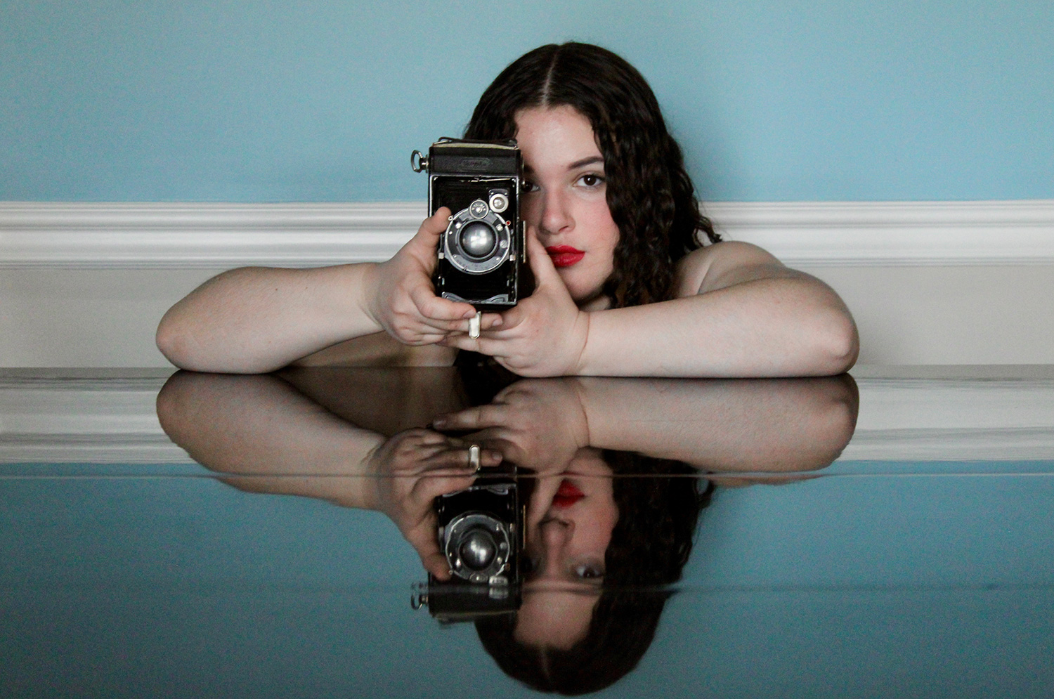Julia Wysocki ’29 holding an old camera.