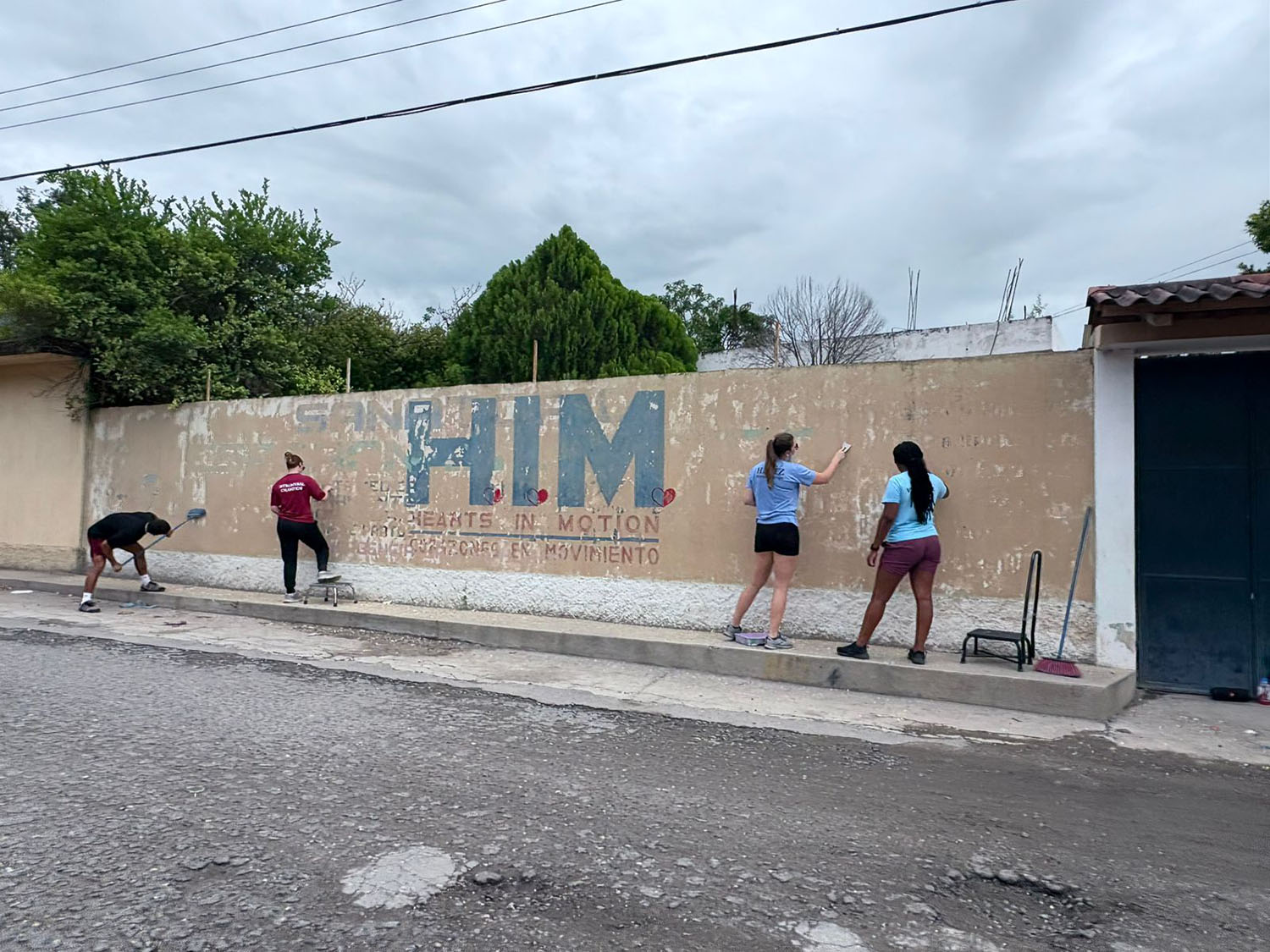 Doctor of Physical Therapy students painting the Hearts in Motion sign in Guatemala.