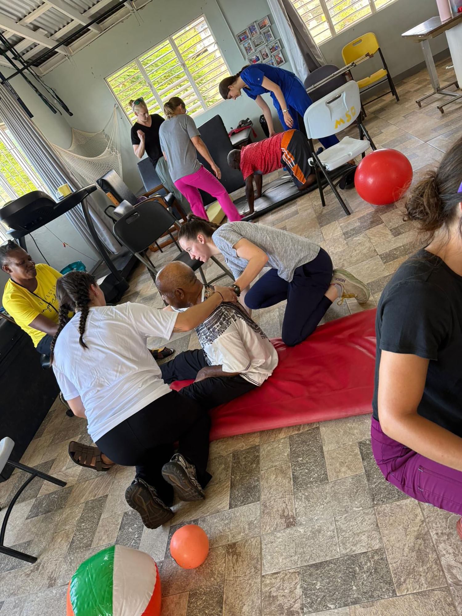 Doctor of Physical Therapy students assisting a patient in Jamaica.